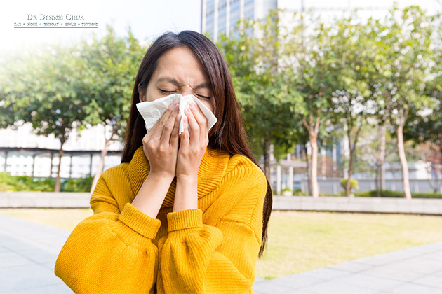 A woman who is sneezing
