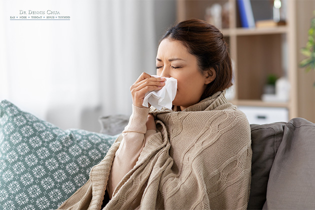 A woman who is sneezing