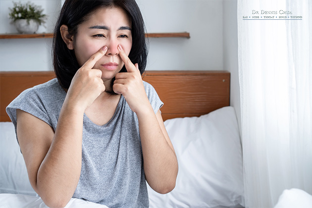 A woman with a red nose who suffers from allergic rhinitis