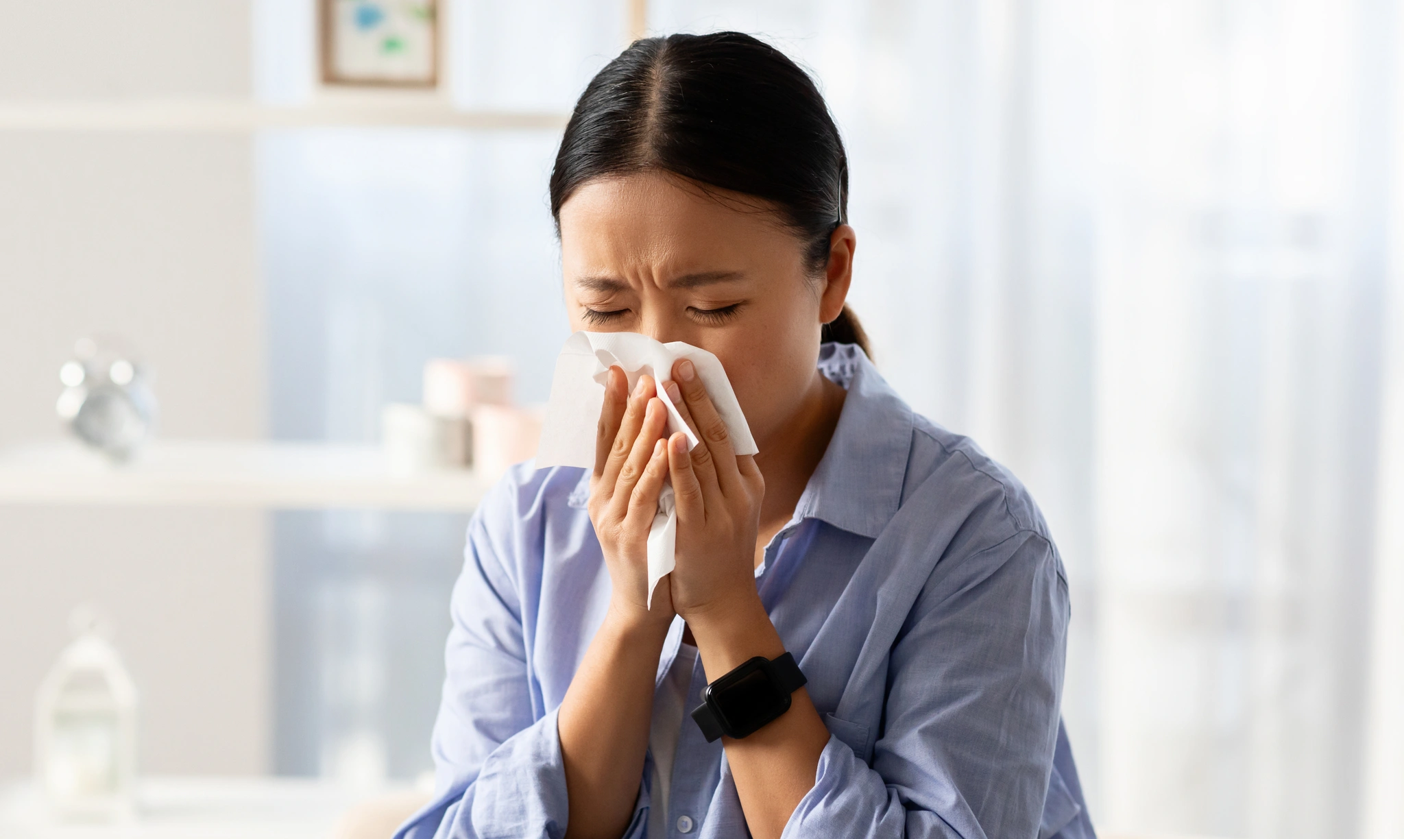 upset young asian woman sitting sofa home crying