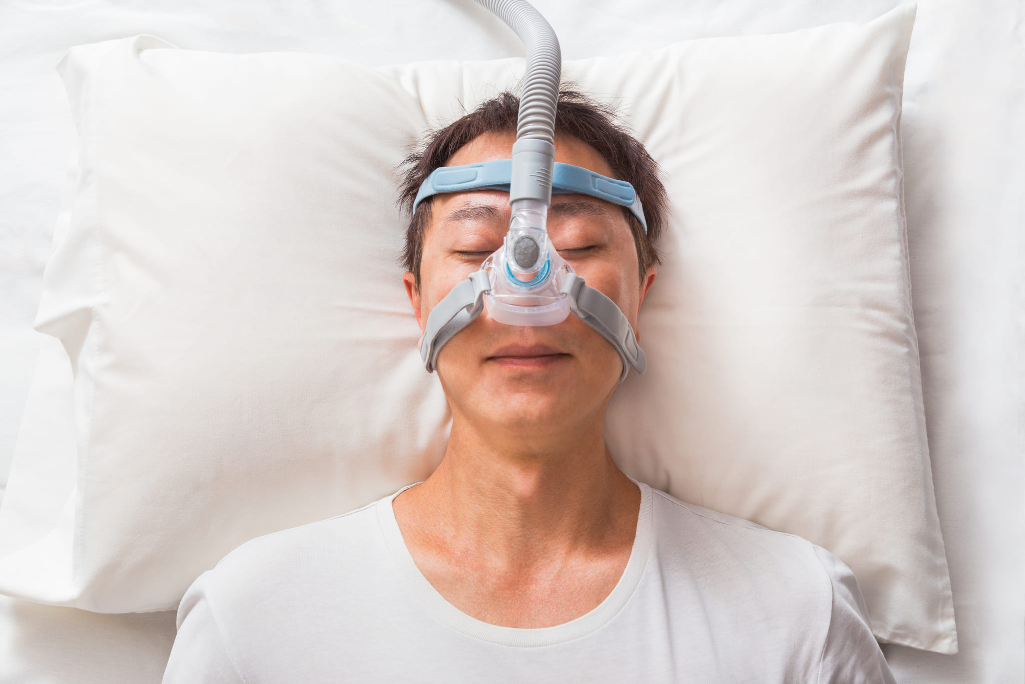 middle age asian man sleeping his bed wearing cpap mask people with sleep apnea