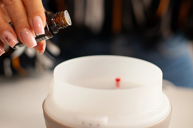 Adding essential oils to a diffuser for rhinitis relief