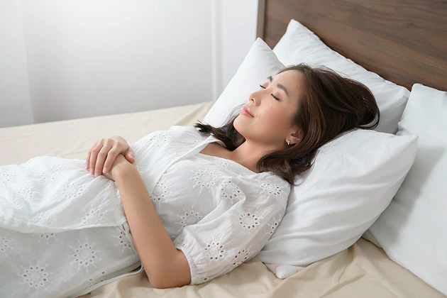 Woman sleeping with head elevated to relieve nasal congestion